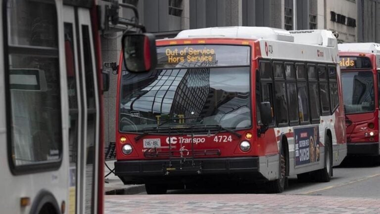 red and white bus with "Out of Service" sign