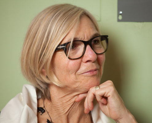 blond woman with black glasses