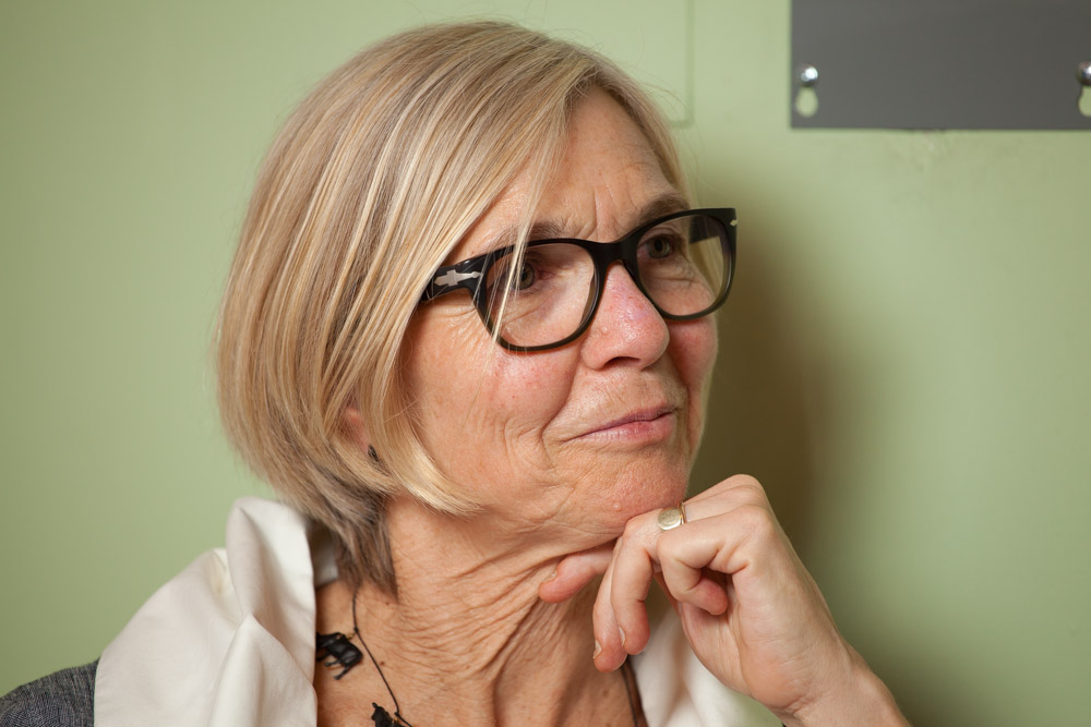 blond woman with black glasses