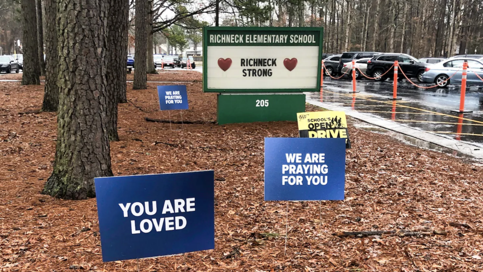 front of elementary school with signs expressing encouragement
