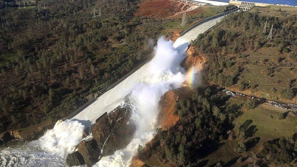 aerial view of water overflow on damaged dam
