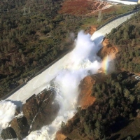 aerial view of water overflow on damaged dam