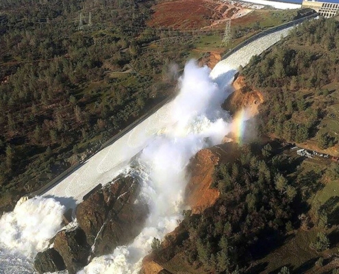 aerial view of water overflow on damaged dam
