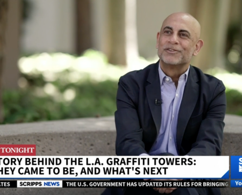 Man sitting outside as part of news footage