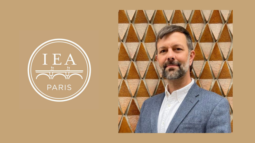Photo of man in gray jacket next to logo reading "IEA Paris"