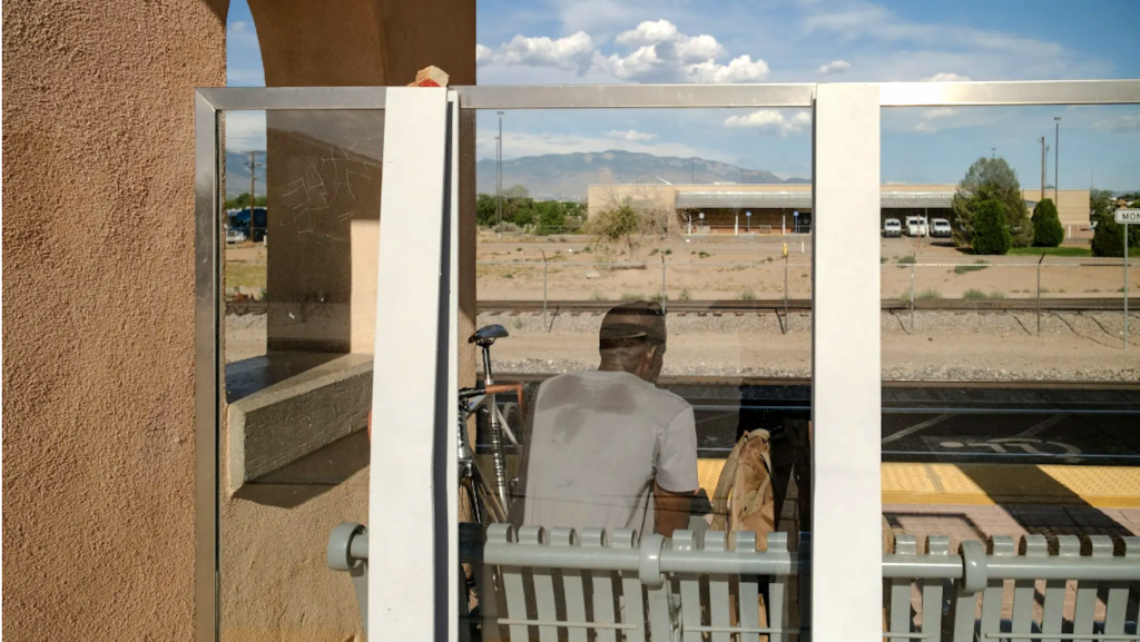 man waiting for train in heat