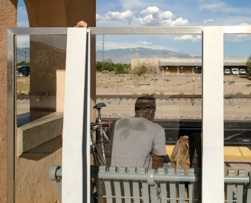 man waiting for train in heat
