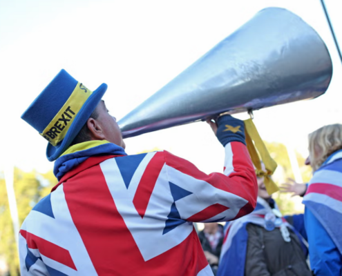 Protester wearing coat depicting British flag