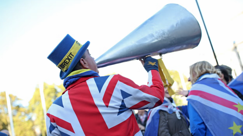 Protester wearing coat depicting British flag