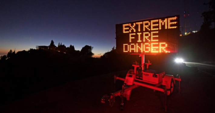 Sign reading 'Extreme Fire Danger' at night