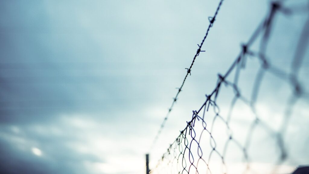 barbed wire above chainlink fence