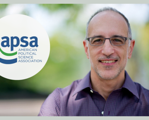 Man with glasses next to blue and green logo