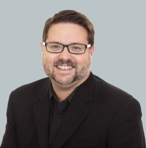 Headshot of a man with glasses