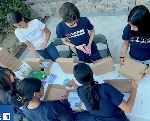 youth filling small cardboard boxes with written material