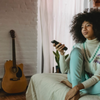 woman on couch with remote