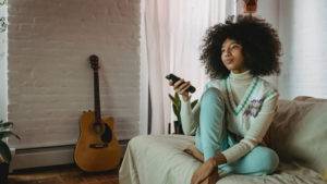 woman on couch with remote