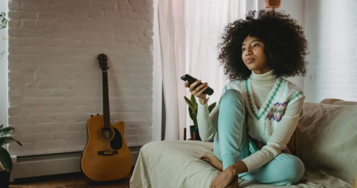 woman on couch with remote