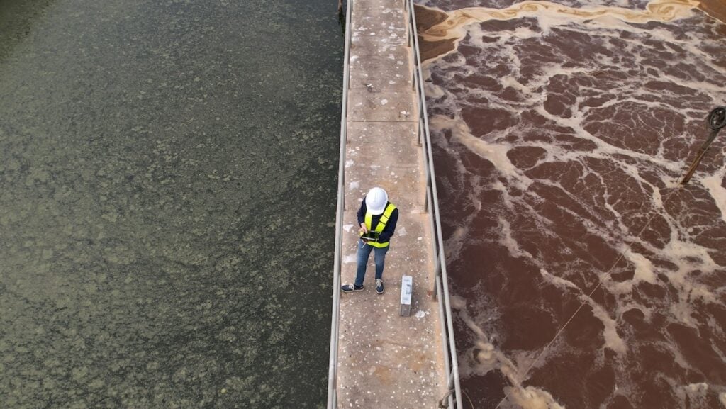 worker on platform at wastewater treatment plant