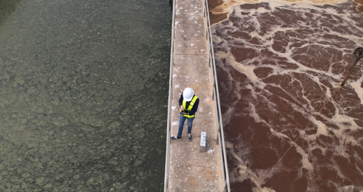 worker on platform at wastewater treatment plant