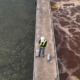 worker on platform at wastewater treatment plant