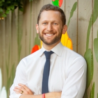 Bearded man in white shirt and tie