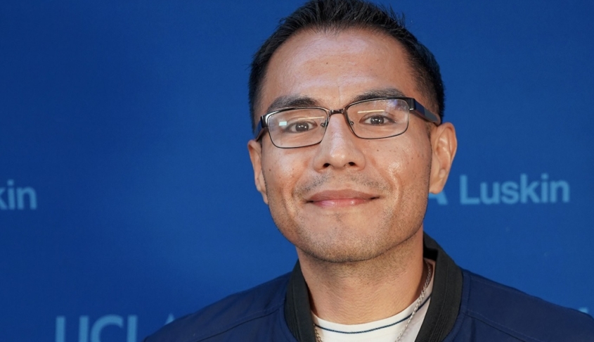 Man with short dark hair and glasses