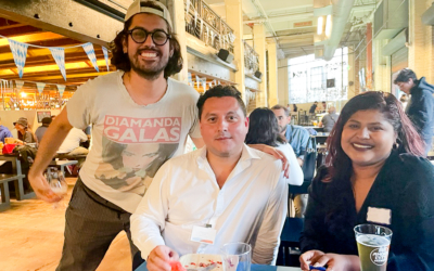 three people gathered around table