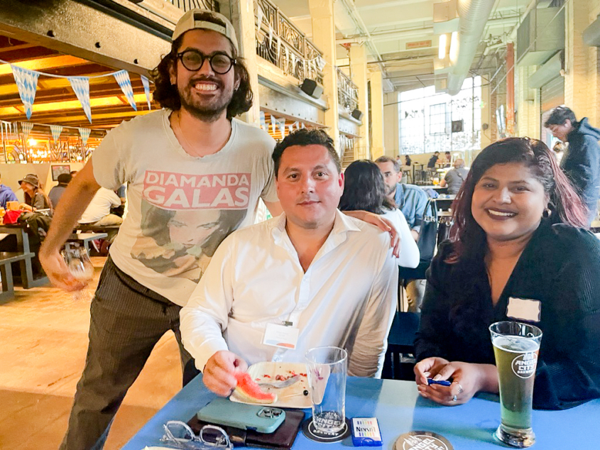 three people gathered around table