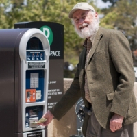 Man at parking kiosk