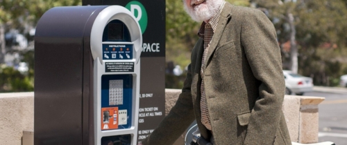 Man at parking kiosk