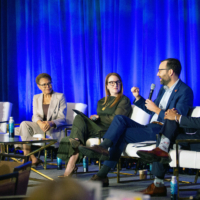 Summit25_01 Photo of speakers on a stage