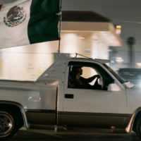 Image of truck flying Mexican flag.