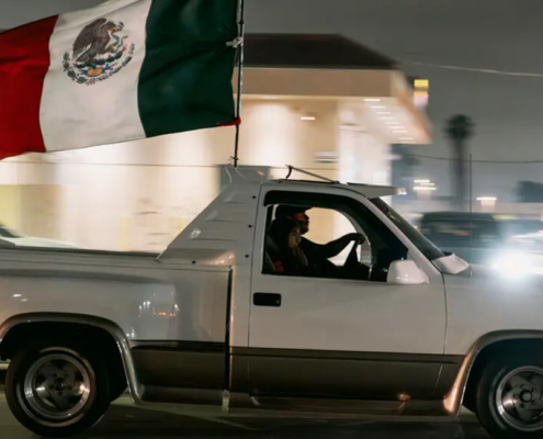 Image of truck flying Mexican flag.