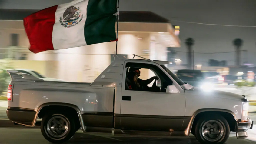 Image of truck flying Mexican flag.