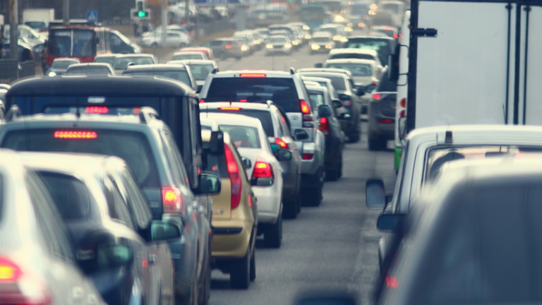 a close up shot of bumper-to-bumper traffic on a road