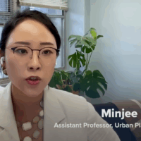 Minjee Kim CNBC Feature Hero Banner Dr. Minjee Kim sits in her office being interviewed via Zoom for a CNBC feature on the rise of gated communities in the U.S.