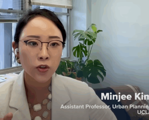 Dr. Minjee Kim sits in her office being interviewed via Zoom for a CNBC feature on the rise of gated communities in the U.S.