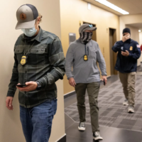 08062025_ICE_Officers-06012025-NW_180224 (1) ICE agents arrive outside of a courtroom to detain someone at Seattle Immigration Court in June in downtown Seattle. Data shows immigration enforcement has indeed scaled up in Washington. Arrests have climbed, most sharply in June, but not as much as they have nationwide. Most of those arrested in Washington and nationwide do not have a criminal record. (Nick Wagner / The Seattle Times)