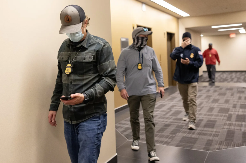 ICE agents arrive outside of a courtroom to detain someone at Seattle Immigration Court in June in downtown Seattle. Data shows immigration enforcement has indeed scaled up in Washington. Arrests have climbed, most sharply in June, but not as much as they have nationwide. Most of those arrested in Washington and nationwide do not have a criminal record. (Nick Wagner / The Seattle Times)