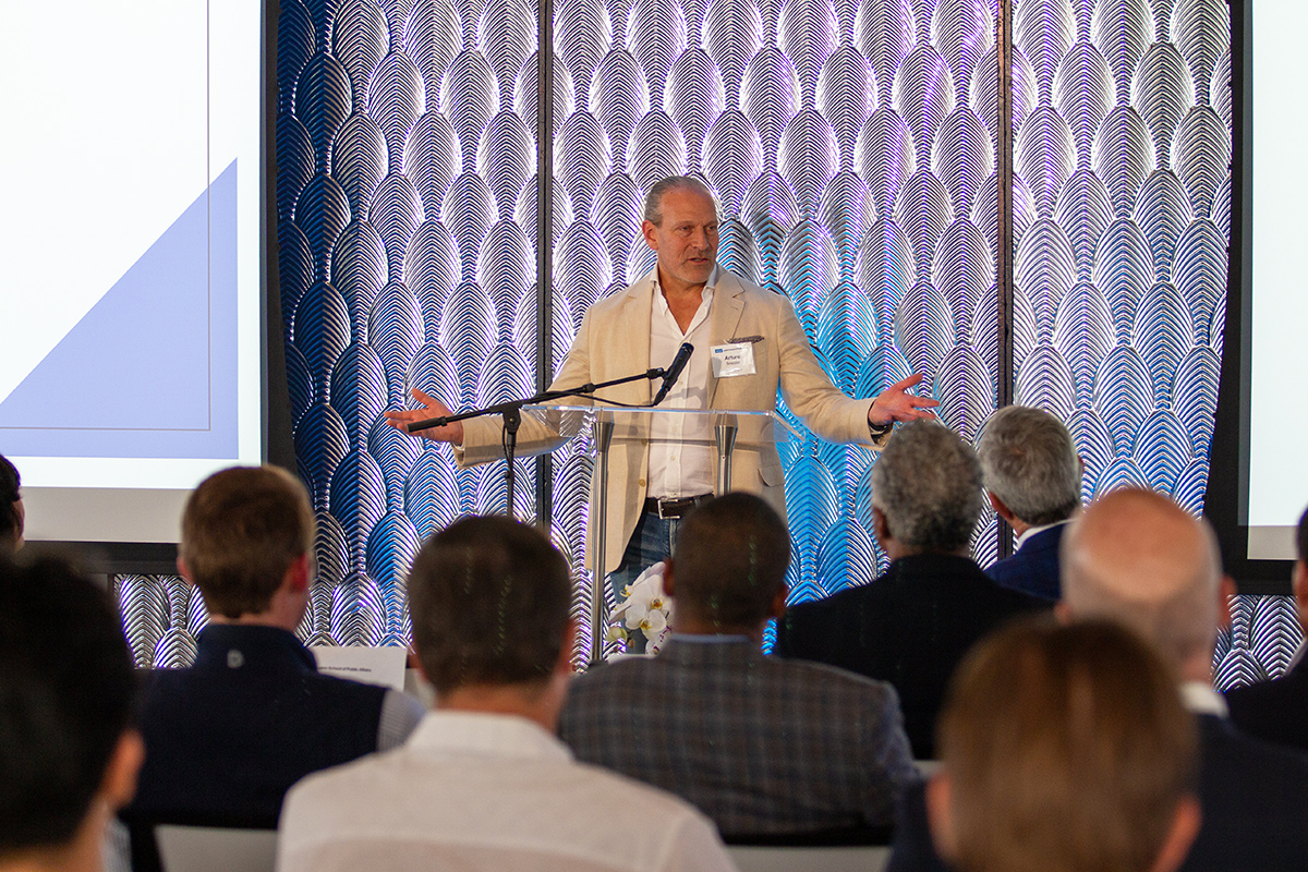 MRED_landing_industry_partners A man addresses a seat crowd from a podium