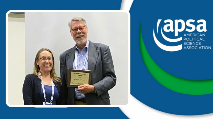 Photo of professor Mark Peter holding the Career Achievement Award with Julianna Pacheco who presented the award.