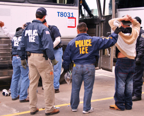 Photo of ICE agents making an arrest.