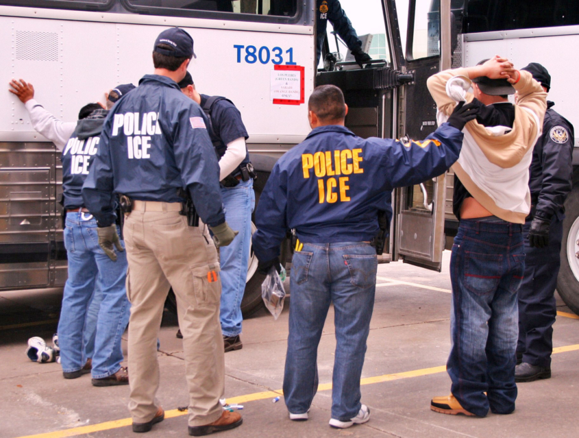 Photo of ICE agents making an arrest.
