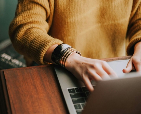 woman typing on laptop