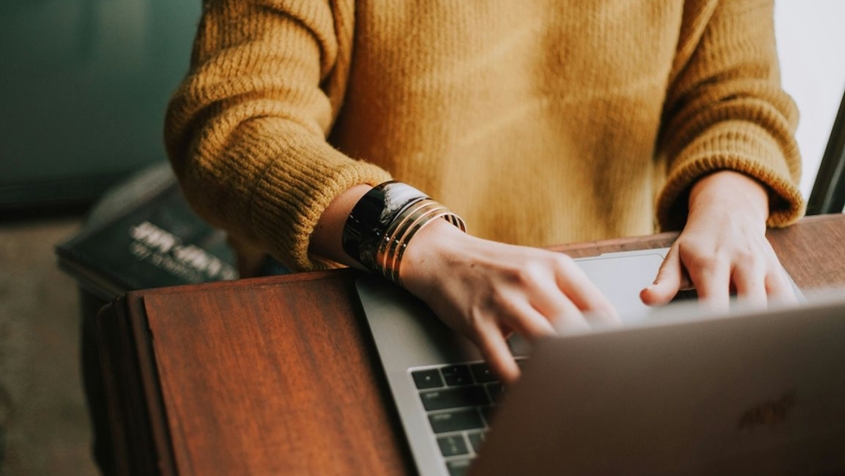 woman typing on laptop