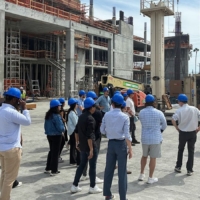 Students in blue hard hats at construction site