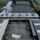 Aerial view of school campus with solar panels on roofs.