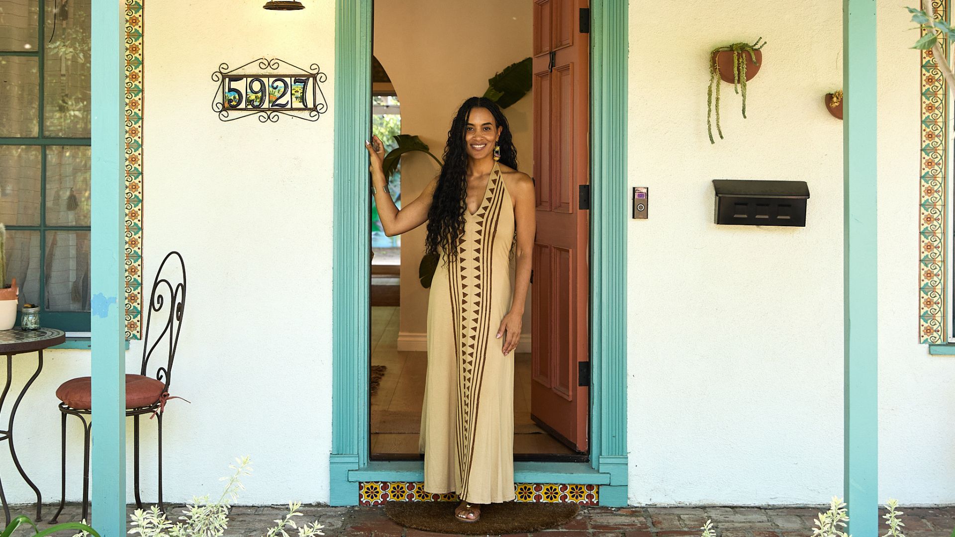 Tamika Lewis stands at the doorway entrance in front of the Women of Color Therapy and Wellness Center