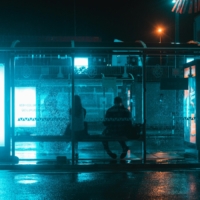 Transportopia-pexels-krebsatka-19092247 two people at bus stop at night