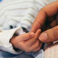 aditya-romansa-5zp0jym2w9M-unsplash infant hand held by adult hand